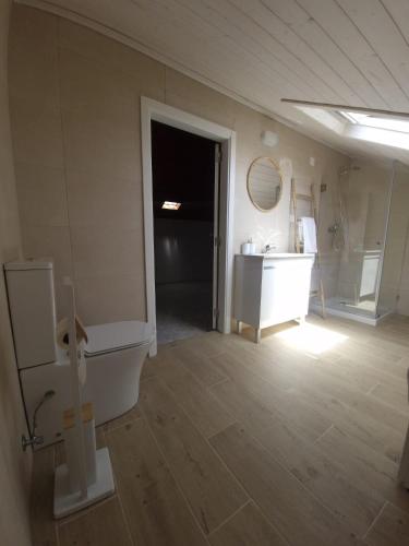 a bathroom with a tub and a sink and a toilet at Casa Amarela in Zambujeira do Mar