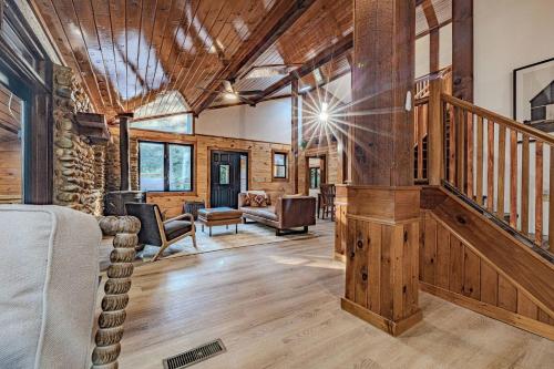a room with a staircase and a living room at Fall Break+Family Cabin+Game Room+Fire Pit+Hot Tub in Wear Valley