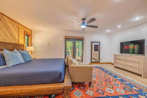 a bedroom with a bed and a flat screen tv at Fall Break+Family Cabin+Game Room+Fire Pit+Hot Tub in Wear Valley