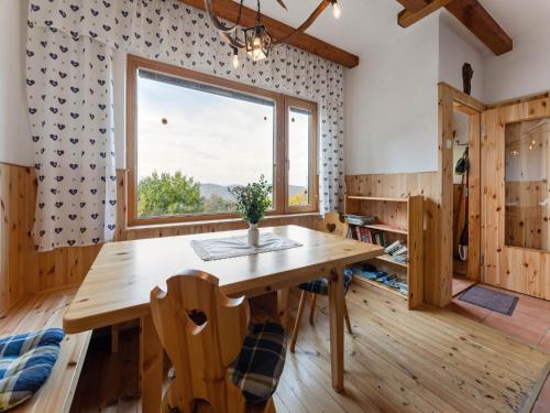 a dining room with a wooden table and a window at Alpine Hut in Eberstein near Ski Area in Eberstein