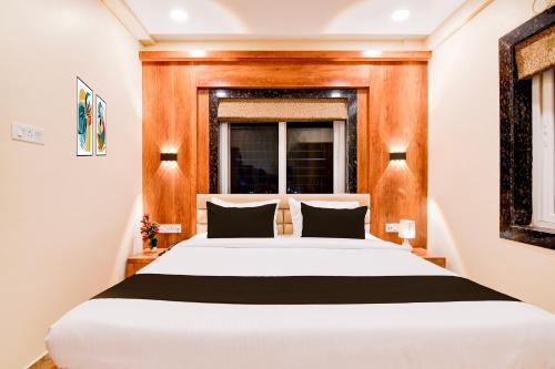 a bedroom with a white bed and a window at Hotel O Grand Inn in kolkata