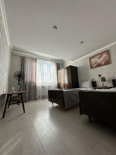 a hotel room with a bed and a desk and a table at GarInna in Gyumri