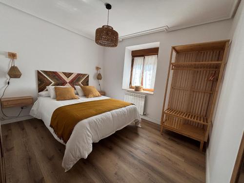 a bedroom with a large bed and a window at El Refugio de los Corrales in San Mateo