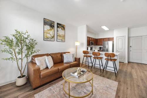 a living room with a couch and a table at Cozy One-Bedroom Retreat in Frisco
