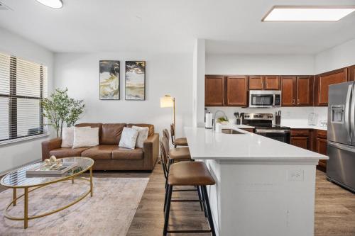 a kitchen and living room with a couch and a table at Cozy One-Bedroom Retreat in Frisco