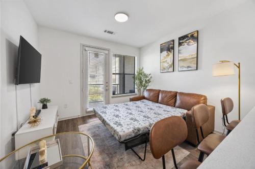 a living room with a couch and a table at Cozy One-Bedroom Retreat in Frisco