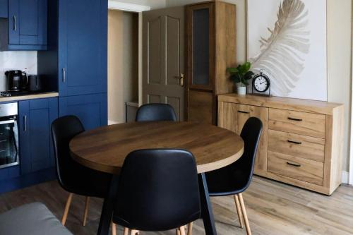 a kitchen with a wooden table and black chairs at Campbell's in Augher
