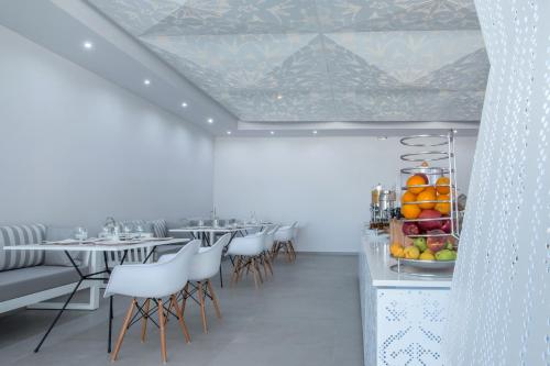 a dining room with tables and chairs with fruit on display at Golden Milos Beach in Provatas