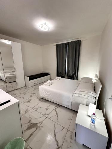 a bedroom with a white bed and a marble floor at a casa di Luca in Florence
