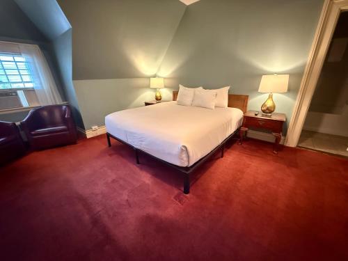 a bedroom with a white bed and a window at Stonehurst Manor Breakfast & Dinner Included in North Conway