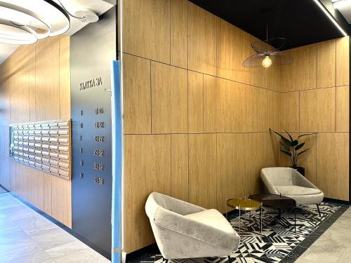 a lobby with two chairs and a table at Michalczyka 3A - Self Check-In 20h - Parking in Wrocław