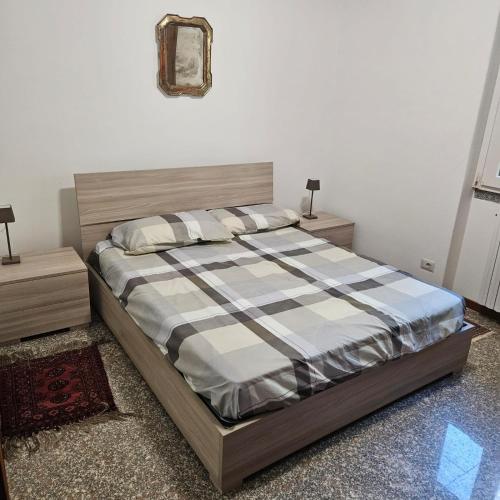 a bedroom with a bed and two night stands at Villetta dei pini in Canzo