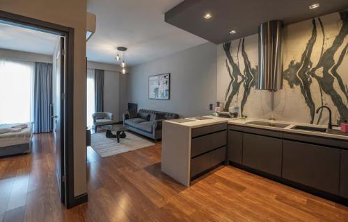 a kitchen and a living room with a couch at Benesta Guest Teori in Istanbul