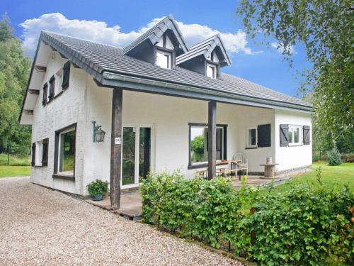 a white house with a patio in front of it at Scenic Stay in Xhoffraix in Xhoffraix