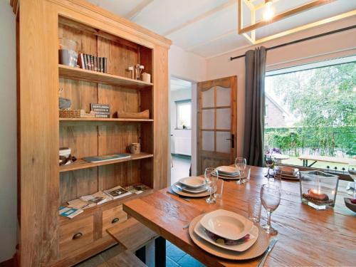a dining room with a wooden table and a large window at Scenic Stay in Xhoffraix in Xhoffraix