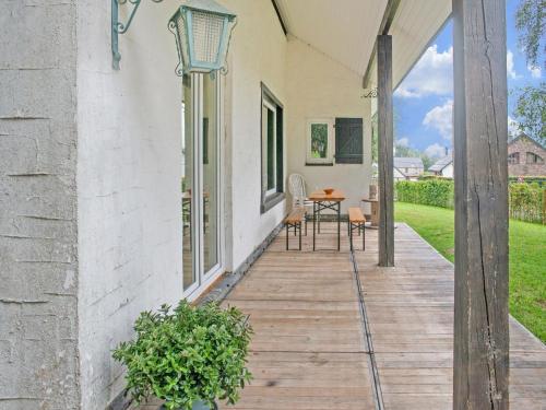 a porch of a house with a table and chairs at Scenic Stay in Xhoffraix in Xhoffraix