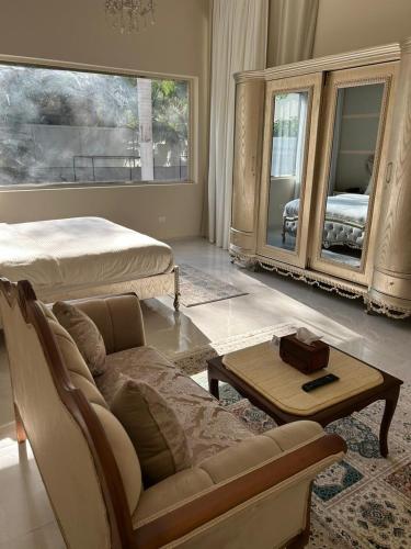 a living room with a couch and a bed at The H Zamalek Suites in Cairo
