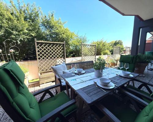 a wooden table and chairs on a patio at Strandbude 4 in Dahme