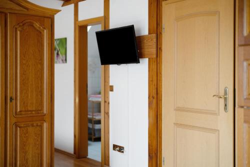 a flat screen tv on a wall next to a door at Gästehaus Weingut Mangel in Endingen