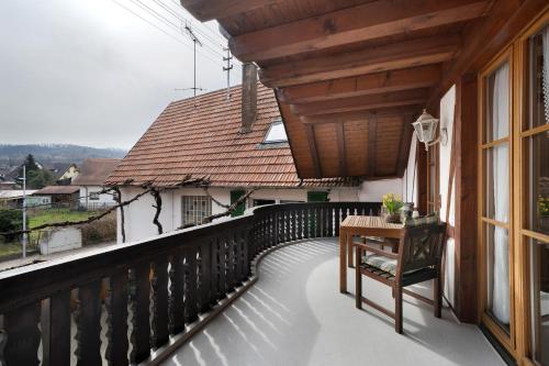 a balcony with a table and a window at Gästehaus Weingut Mangel in Endingen