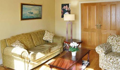 a living room with a couch and a table at Brofida B&B in Dublin