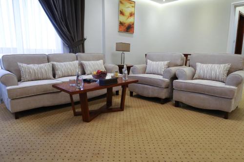 a living room with two couches and a coffee table at Best Day Hotel and Resorts المحمدية in Jeddah