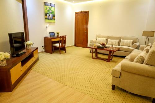 a living room with a couch and a tv at Best Day Hotel and Resorts المحمدية in Jeddah
