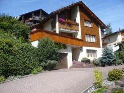 a large house with a balcony on top of it at Ferienwohnung Kathriner Durrer in Sarnen