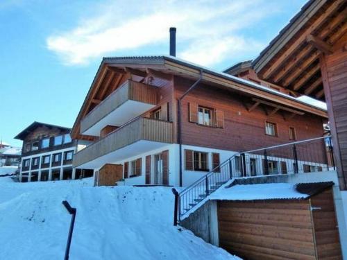 a building with snow in front of it at Pfrundmatte 12 in Aeschi bei Spiez