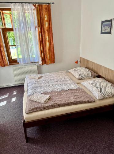 a bedroom with a bed in a room at Pension Bystřenka in Špindlerův Mlýn