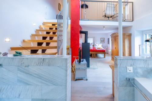 a living room with a staircase and a bedroom at Dongio, Acquarossa in Dongio