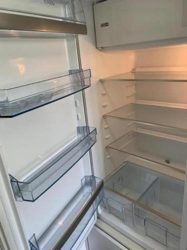 an empty refrigerator with its door open and its shelves at Ferienwohnung Gian in Davos