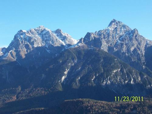 a view of a mountain range with snow capped mountains at Cajosftan in Ftan