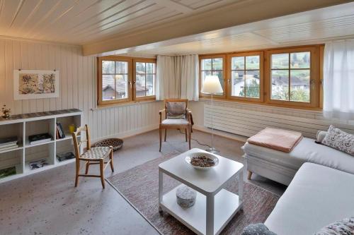 a living room with a couch and a table at Haus Zum Reh in Krummenau