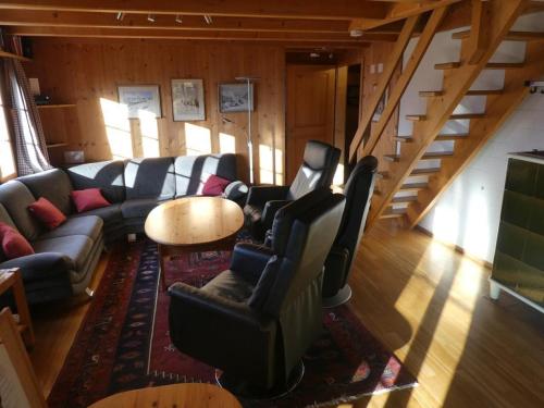 a living room with a couch and chairs and a table at Ferienhaus in Hasliberg Wasserwendi