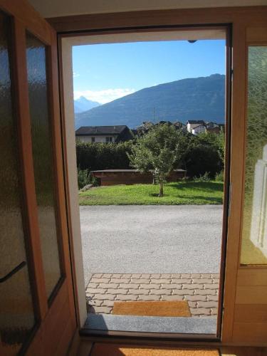an open door with a view of a driveway at Ferienwohnung Dent Blanche in Savièse