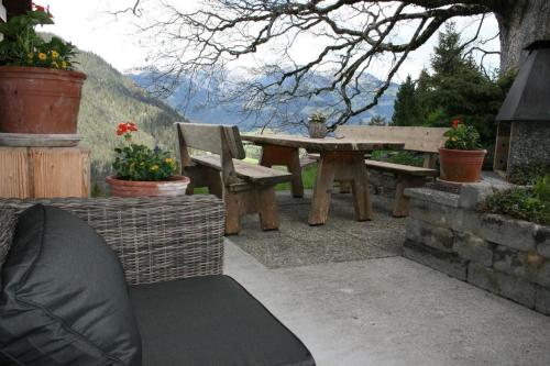 a picnic table and bench on a patio at Fewo Mit Herz in Horboden