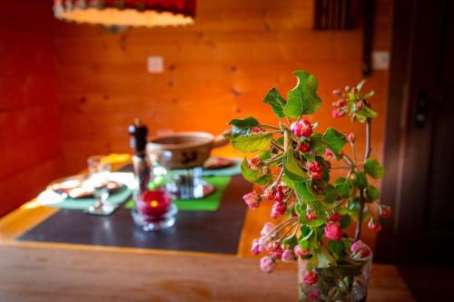 a vase filled with flowers on top of a table at Ferienhaus Fromsenrüti in Walzenhausen