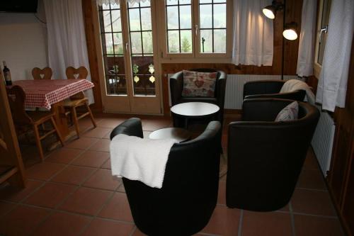 a living room with chairs and a table and a dining room at Fewo Mit Herz in Horboden