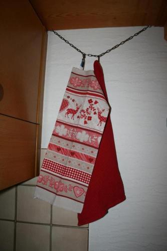 a red and white towel hanging on a chain at Fewo Mit Herz in Horboden