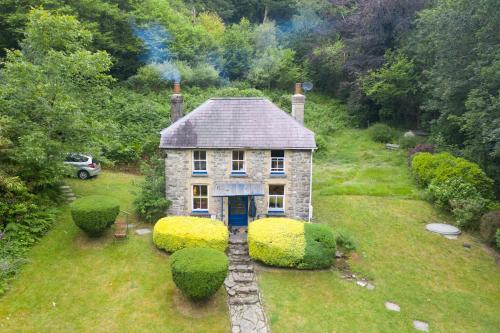 a small house in the middle of a field at Pass the Keys Y Bwythn Welsh Countryside Retreat UK Getaway in Carmarthen