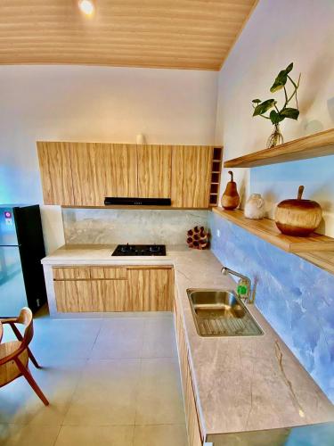 a kitchen with a sink and a counter top at Villa Teduh Canggu in Dalung