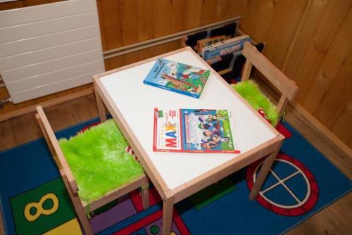 a small table with a toy table and a play table and chairs at 45 Zimmer Ferienwohnung Hofstatthaus in Hasliberg