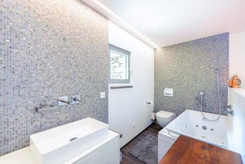 a bathroom with a white sink and a toilet at Malvaglia in Malvaglia