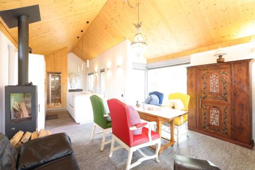 a dining room with a table and colorful chairs at Malvaglia in Malvaglia