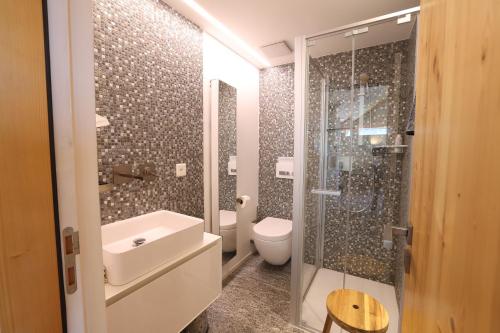 a bathroom with a toilet sink and a shower at Malvaglia in Malvaglia