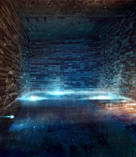 a dark room with a brick wall and blue lights at Exklusive Ferienwohnung Im Hotel Mit Wellness in Laax