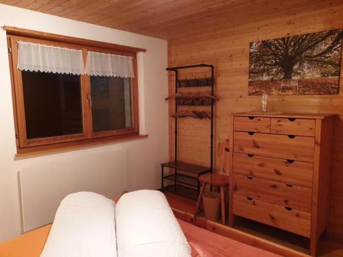 a room with a bedroom with a dresser and a window at Chalet Traumfleck in Necker