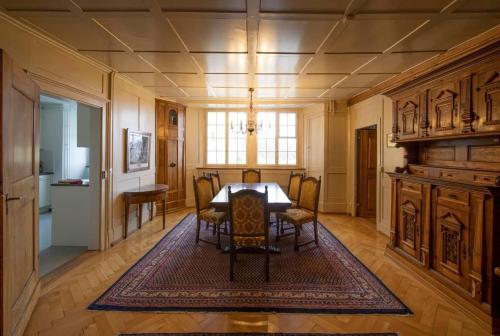 a dining room with a table and chairs at Schloss Heidegg in Gelfingen