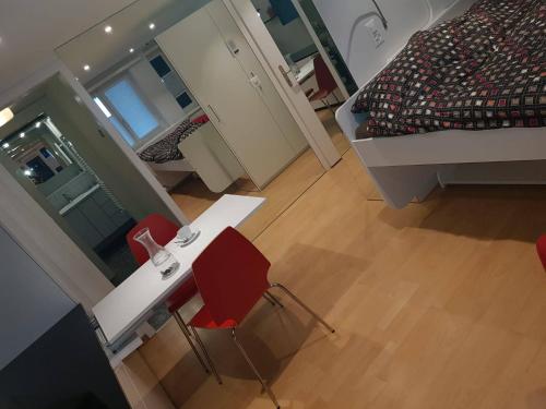 a room with a table and two chairs and a bed at Fw Bacheggli in Brunnen